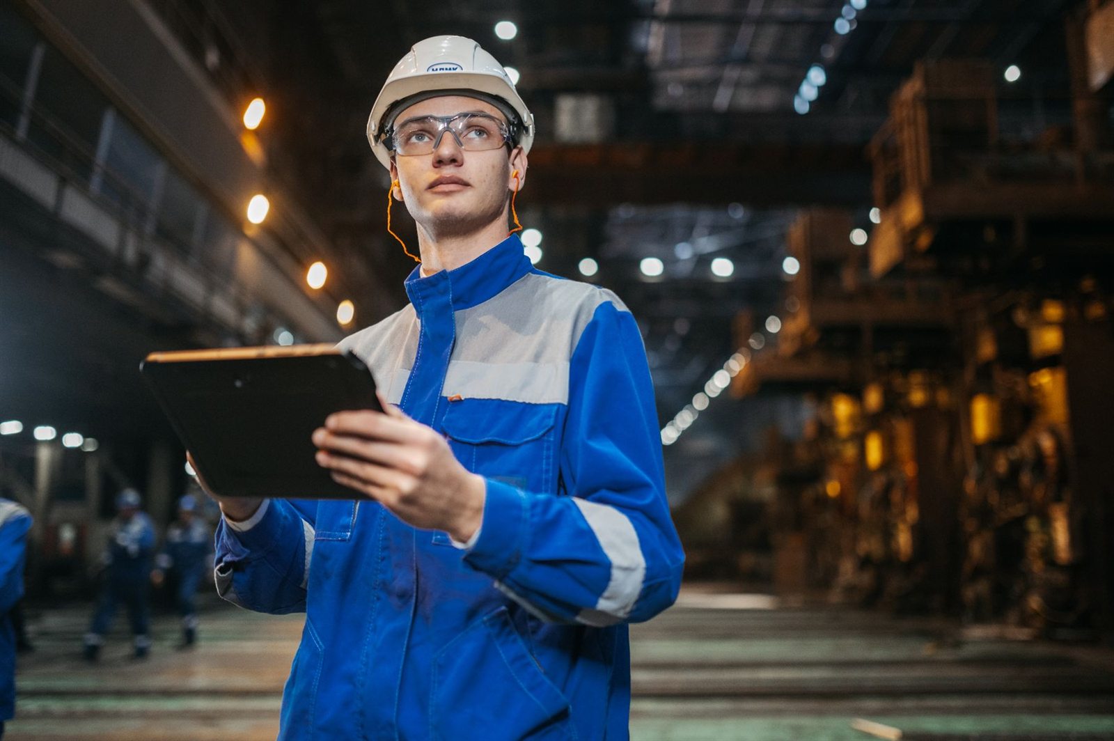Engineer using tablet in an industrial factory